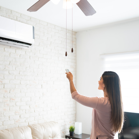 Woman adjusting the temperature on her ductless air conditioning system - mini-split installation - Lake Charles, LA 